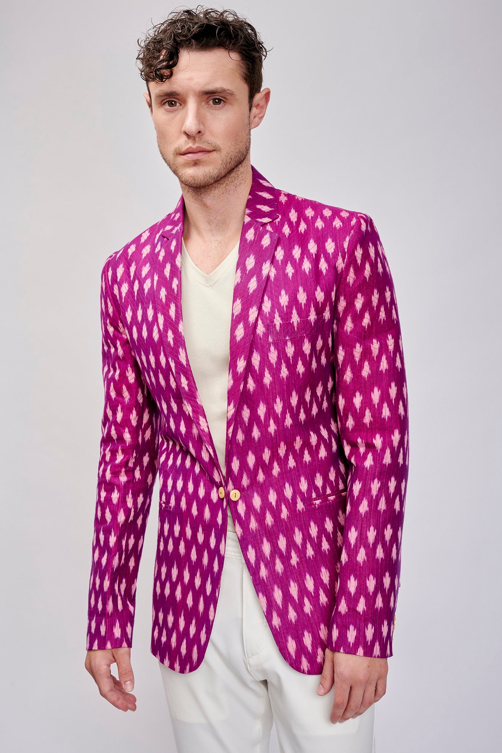 Model wearing a magenta ikat jacket. Handwoven with organic cotton and meticulously hand-stitched for a sustainable and stylish look.