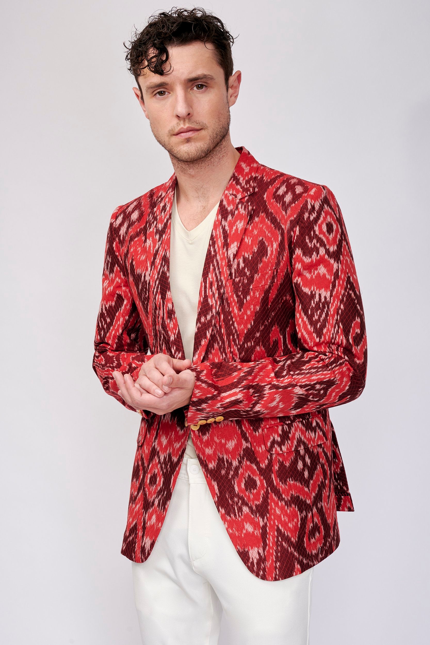 Model wearing a  bright and bold jacket is hand-woven in the ancient art of Ikat.