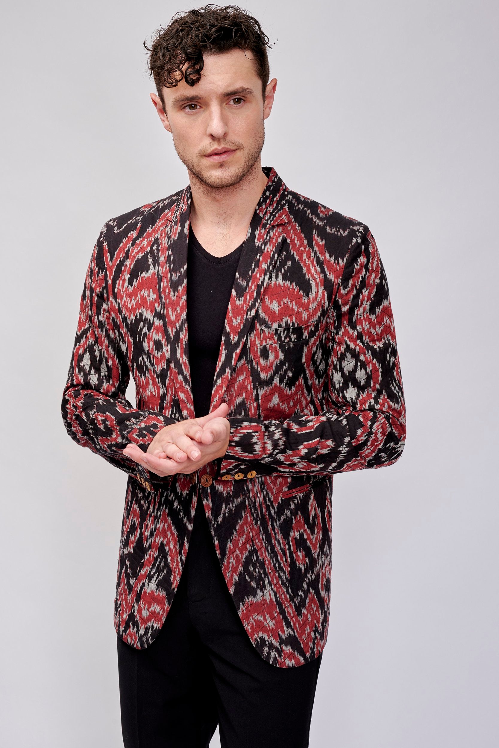 Model wearing a designer blazer, expertly hand-stitched for a sustainable and fashionable look.