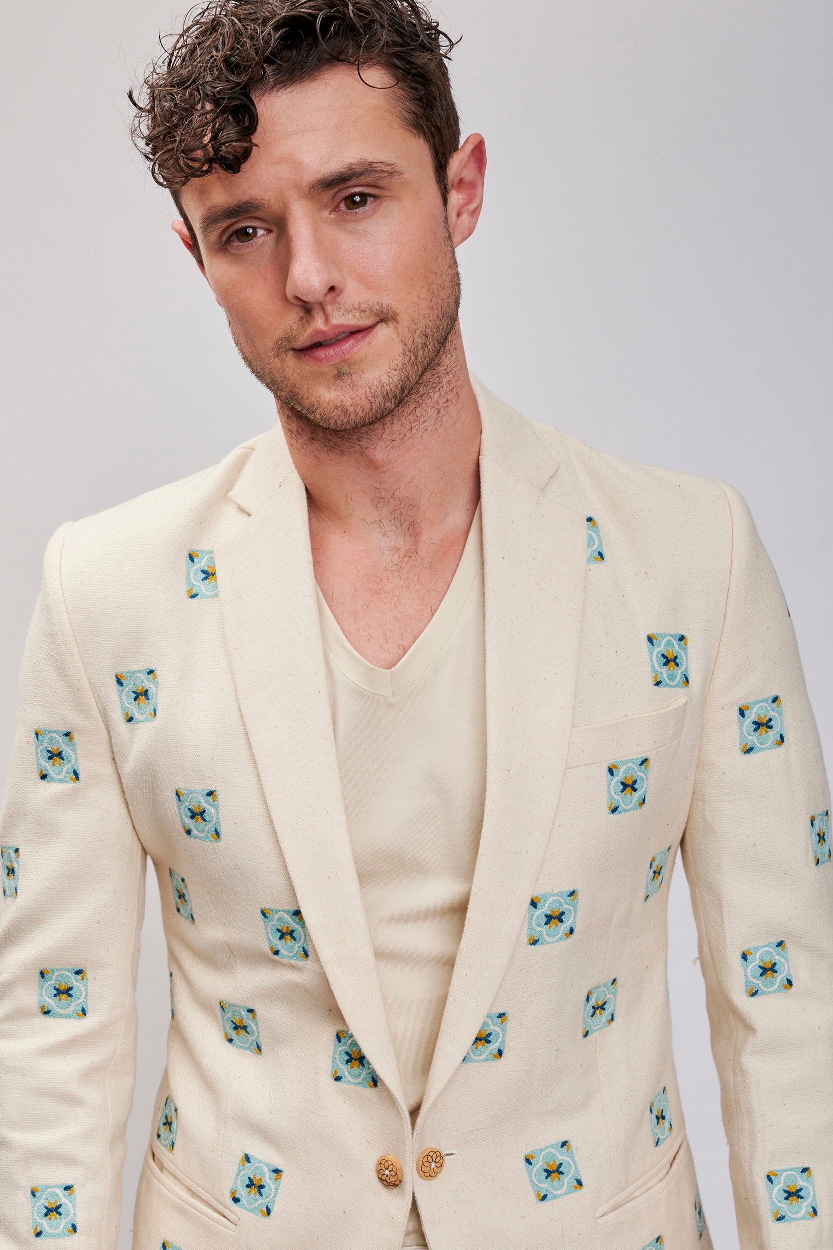 Men's casual blazer made with hemp fabric. Teal color hand embroidered motifs