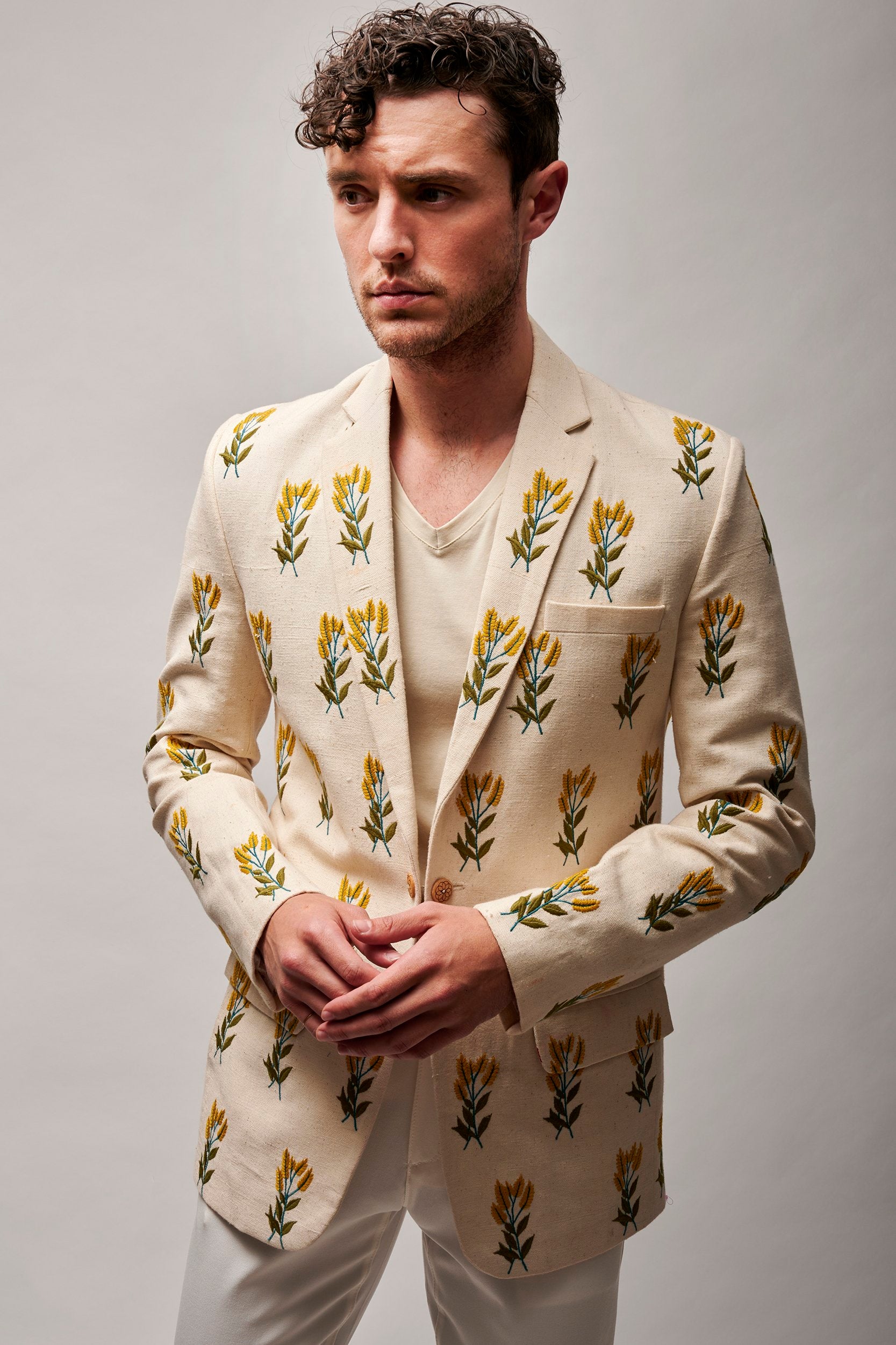 A model wearing a hand embroidered jacket made with organic cotton. Handwoven and hand-stitched, creating a distinctive and eco-friendly fashion piece.
