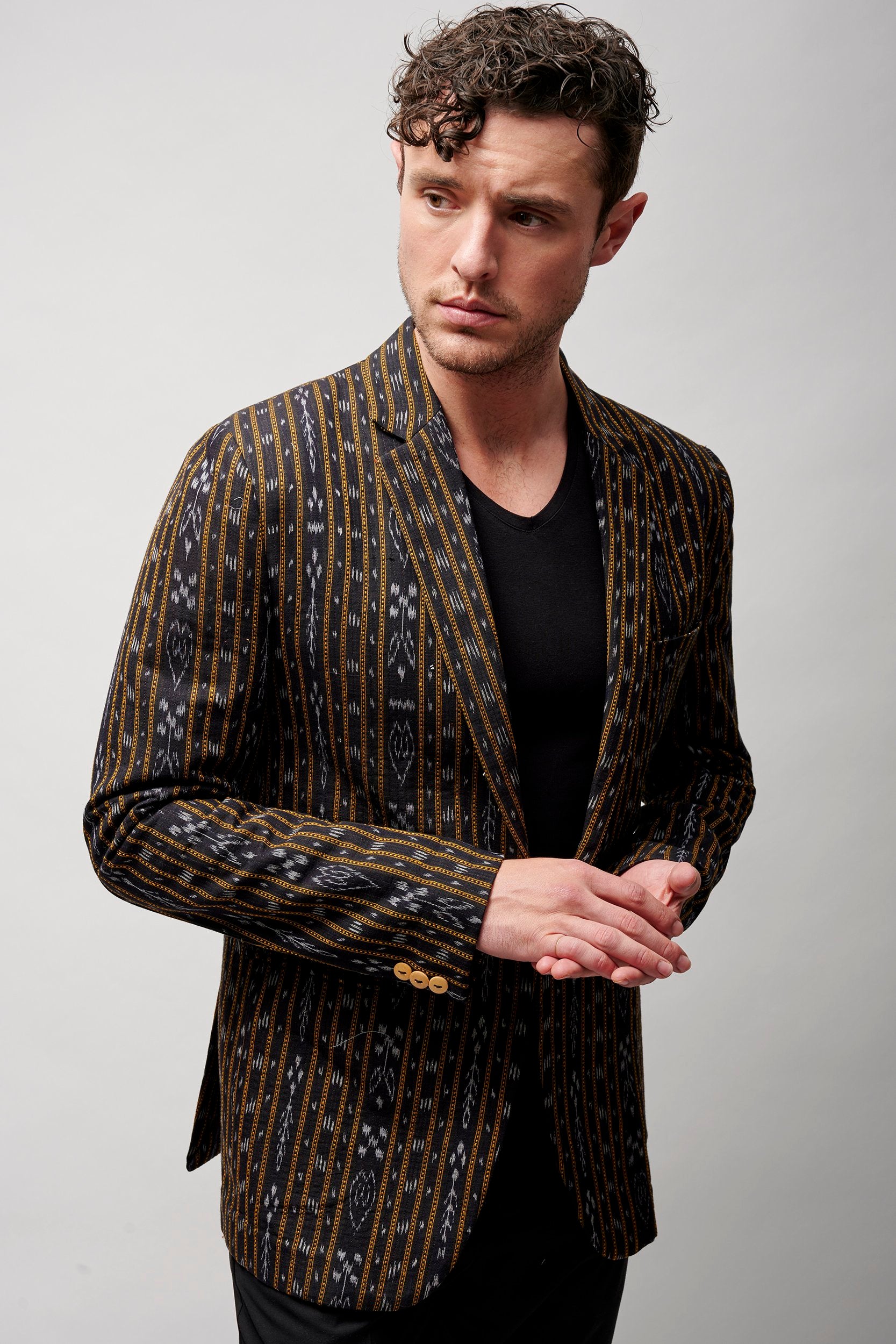 Model wearing a stylish blazer in black. 