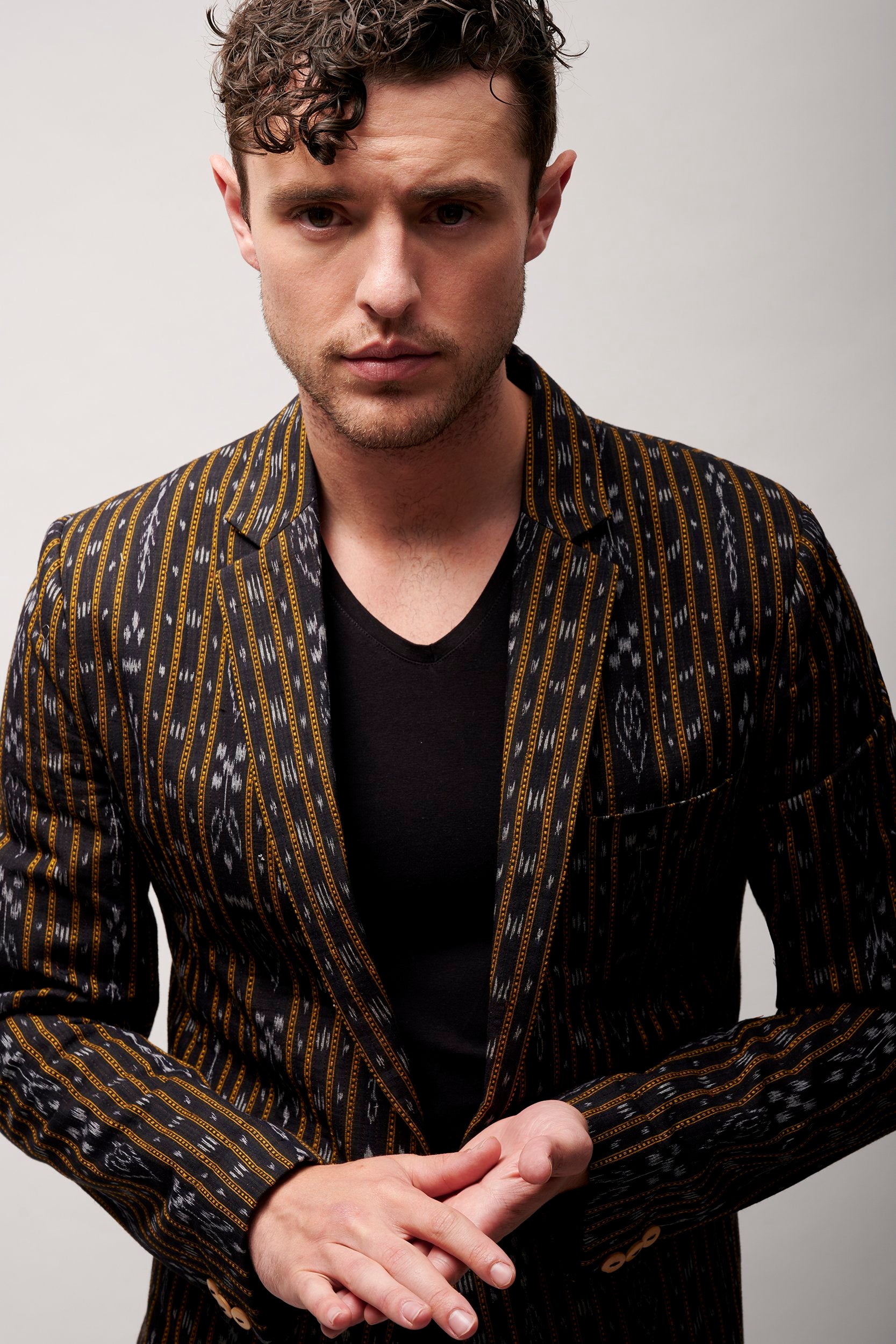 Model wearing a stylish jacket in black. 