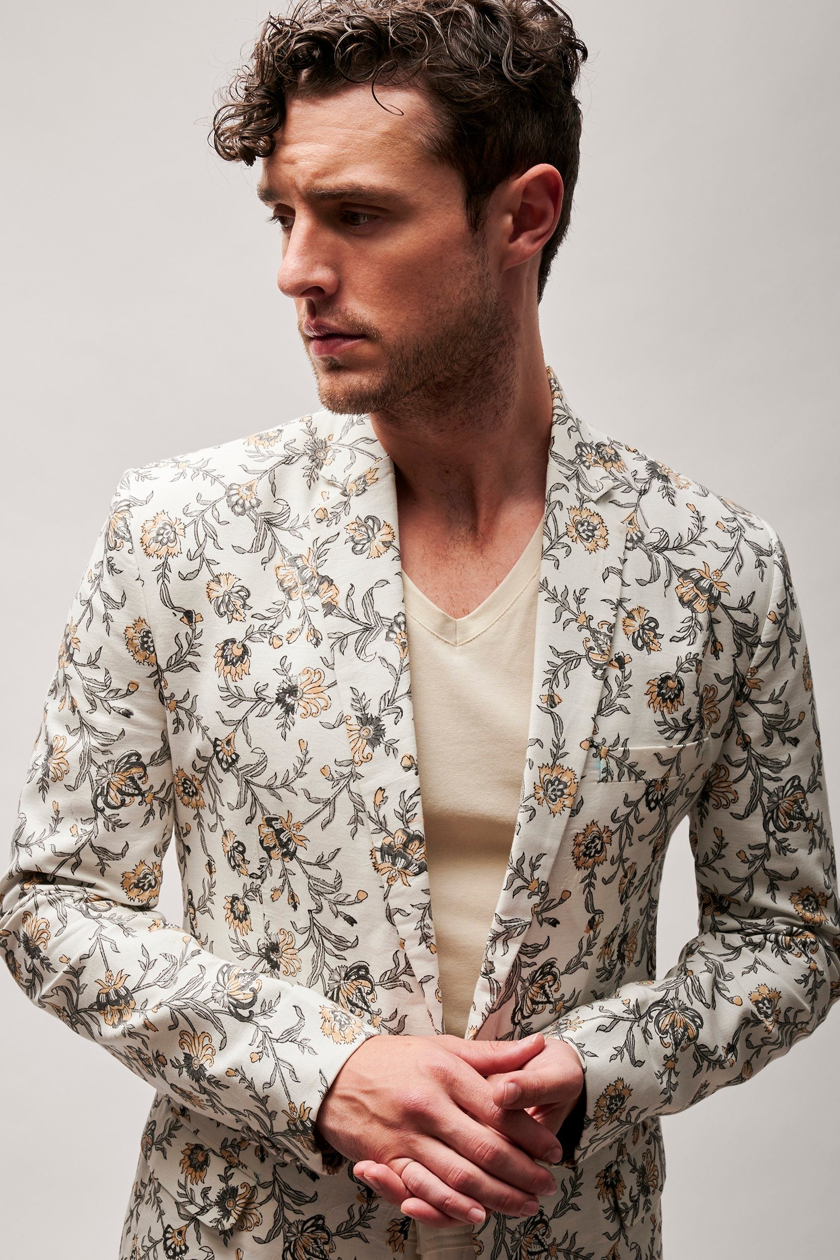 Model wearing a beautiful hand block printed floral blazer made with organic cotton. A perfect blend of style and sustainability in fashion.