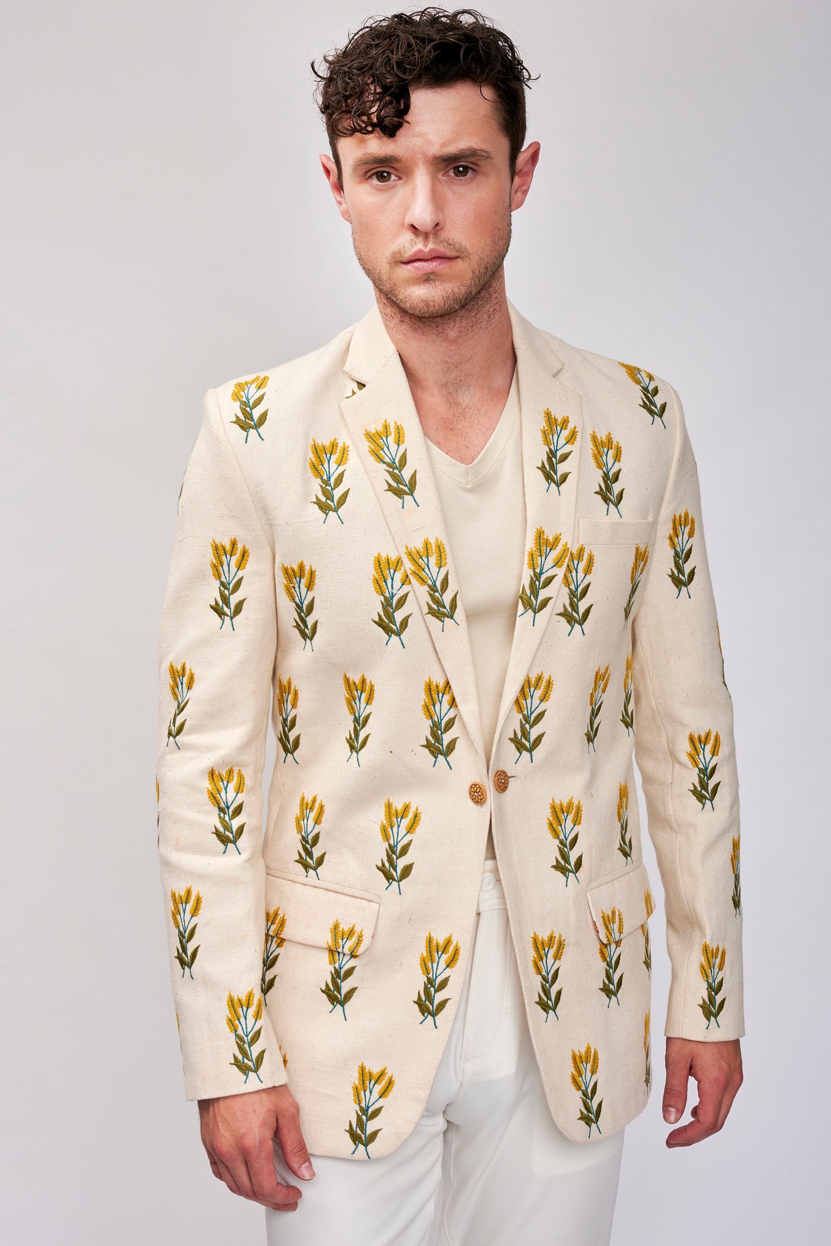 A model wearing a hand embroidered blazer made with organic cotton. A perfect blend of style and sustainability in fashion.