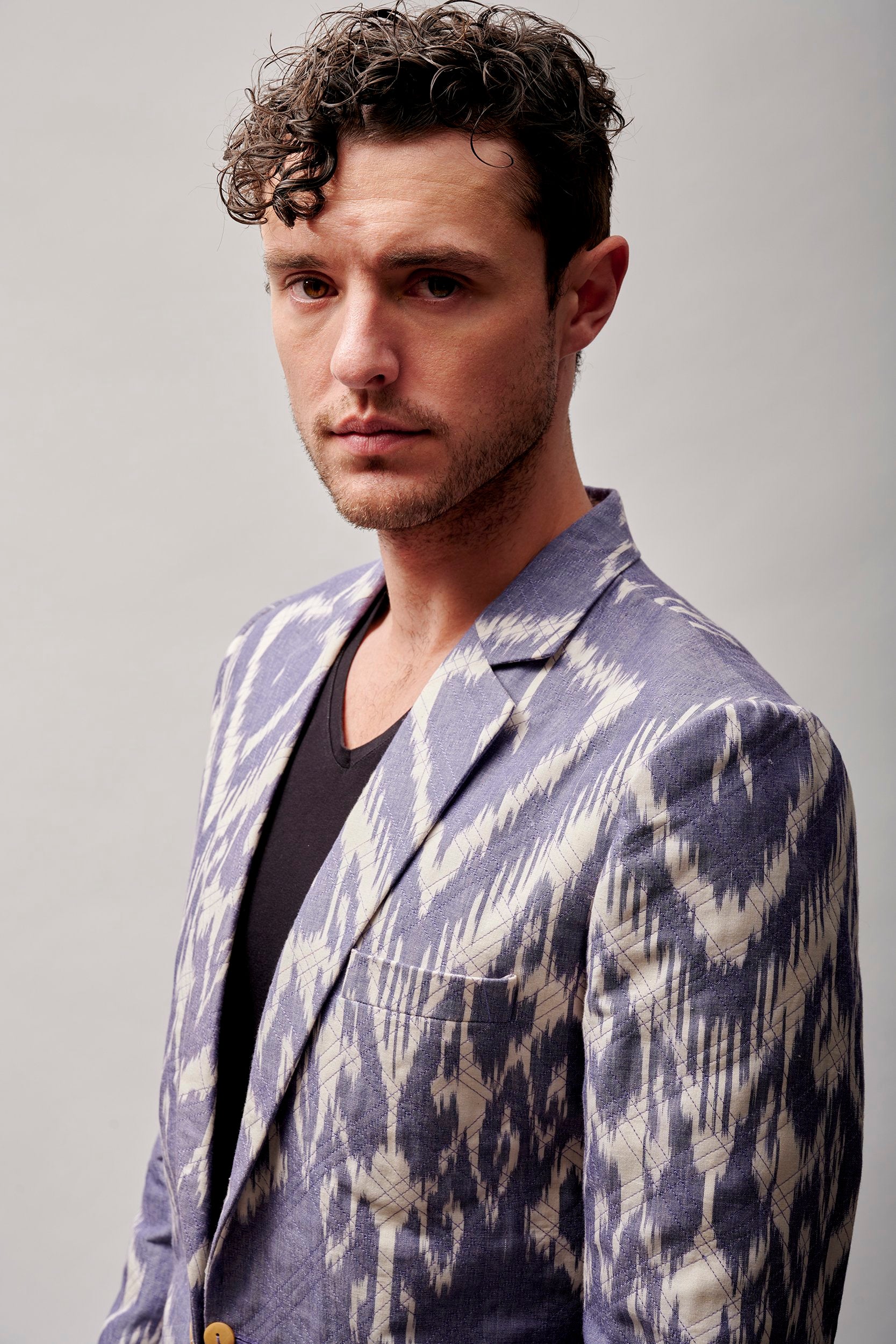 A man wearing a hand-woven gray and white color blazer.