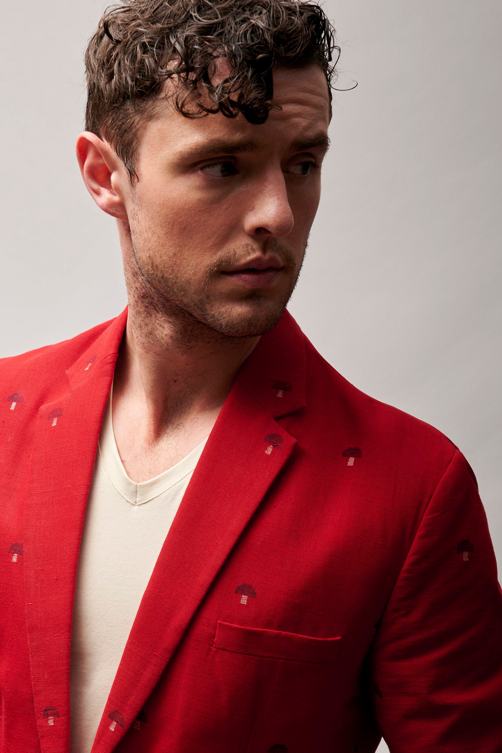 Model wearing a red khadhi blazer. Khadi cotton is hand-woven and is known for it's unique texture that gives it a beautiful rich look.