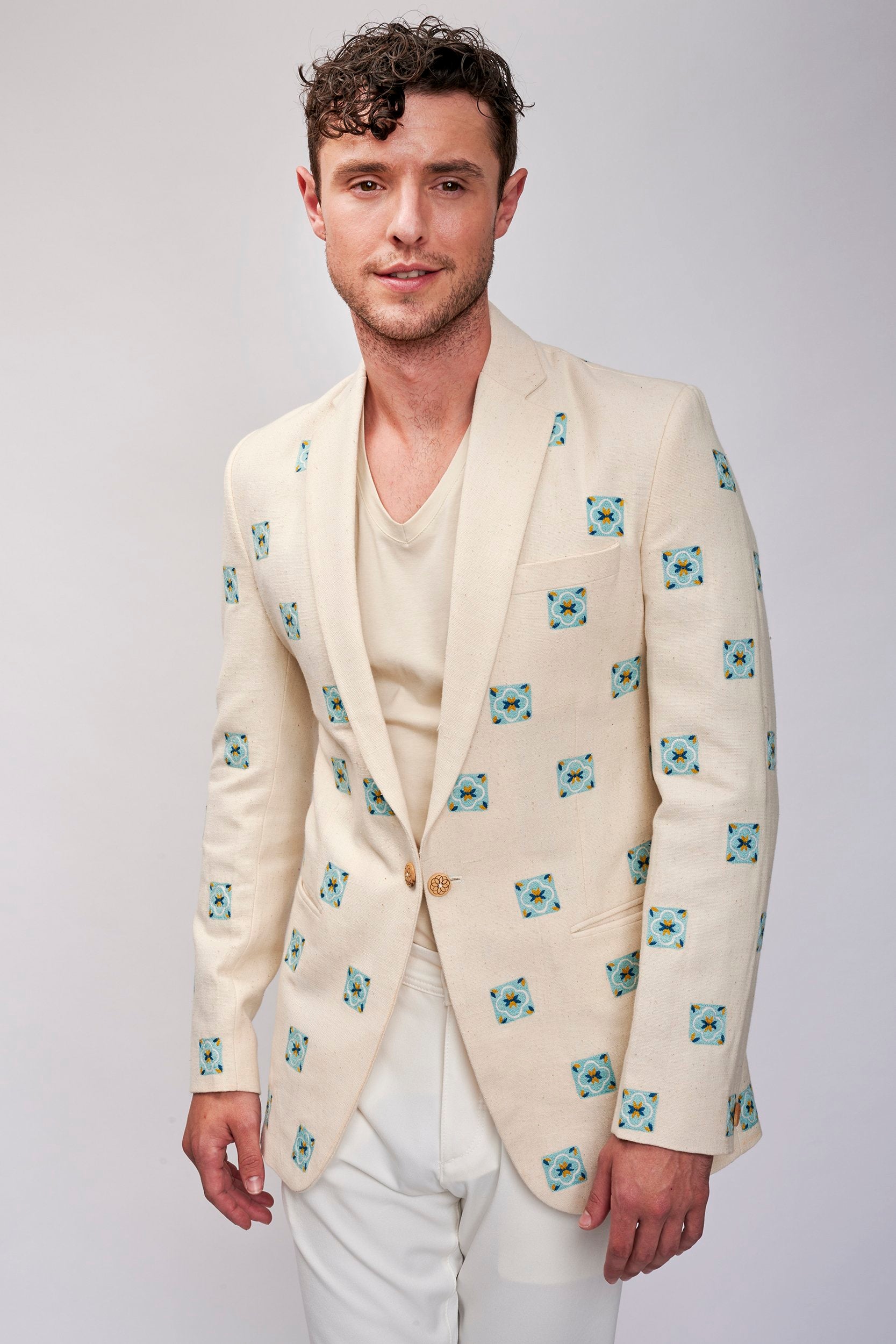 Men's casual blazer made with hemp fabric. Teal color hand embroidered motifs with wooden buttons.