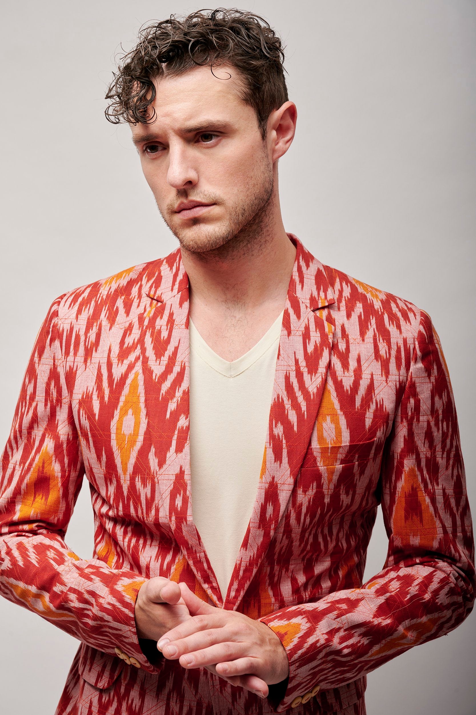 A model wearing a men's party blazer.